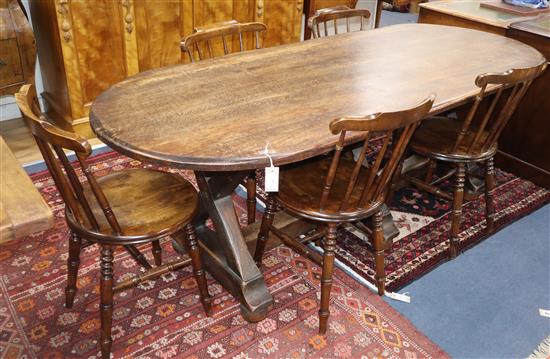 An Arts and Crafts style oak refectory dining table together with five Windsor comb back chairs